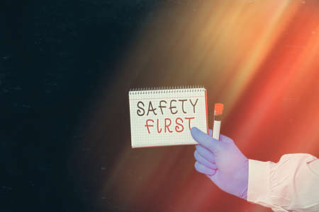 Conceptual hand writing showing Safety First. Concept meaning used to say that the most important thing is to be safe Displaying Sticker Paper Accessories With Medical Gloves Onの写真素材