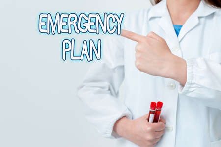 Writing note showing Emergency Plan. Business concept for instructions that outlines what workers...