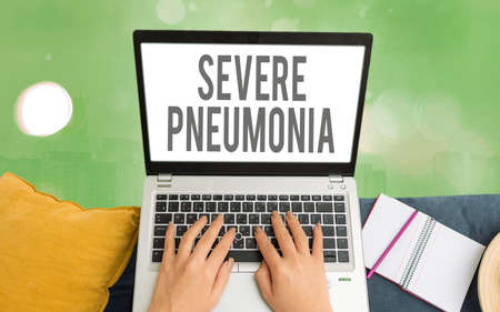 Word writing text Severe Pneumonia. Business photo showcasing acute disease that is marked by inflammation of lung tissue Modern gadgets with white display screen under colorful bokeh backgroundの写真素材