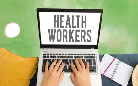 Word writing text Health Workers. Business photo showcasing showing whose job to protect the health of their communities Modern gadgets with white display screen under colorful bokeh backgroundの写真素材