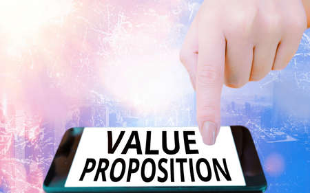 Conceptual hand writing showing Value Proposition. Concept meaning feature intended to make a company or product attractive Modern gadgets white screen under colorful bokeh backgroundの写真素材