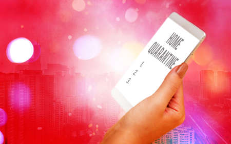 Word writing text Home Quarantine. Business photo showcasing Encountered a possible exposure from the public for observation Modern gadgets with white display screen under colorful bokeh backgroundの写真素材