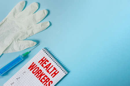 Handwriting text writing Health Workers. Conceptual photo showing whose job to protect the health of their communities Set of medical equipment with notepad for health condition assessmentの写真素材
