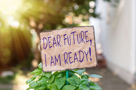 Writing note showing Dear Future I Am Ready. Business concept for Confident to move ahead or to face the future Plain paper attached to stick and placed in the grassy landの写真素材