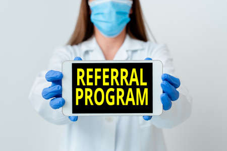 Handwriting text Referral Program. Conceptual photo employees are rewarded for introducing suitable recruits Laboratory technician featuring empty sticker paper accessories smartphoneの写真素材