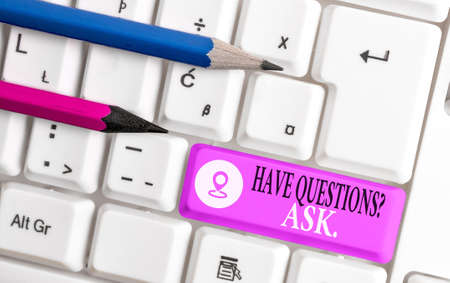 Conceptual hand writing showing Have Questionsquestion Ask. Concept meaning something that you say or write to ask an individual Colored keyboard key with accessories arranged on copy spaceの写真素材
