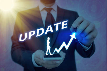 Writing note showing Update. Business concept for by adding Up to date information or making corrections to the current version Arrow symbol going upward showing significant achievementの写真素材