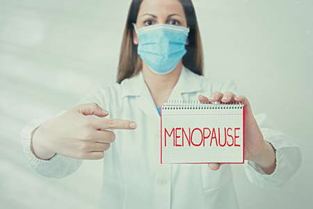 Writing note showing Menopause. Business concept for natural cessation of menstruation that usually occurs around 45 Laboratory technician featuring empty paper accessories smartphoneの写真素材