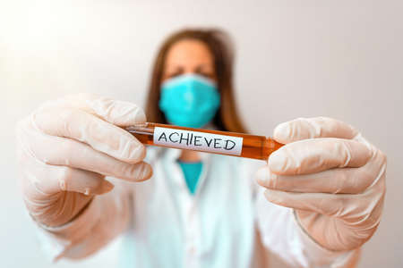 Writing note showing Achieved. Business concept for brought to or marked by a high degree of development or refinement Laboratory blood test sample for medical diagnostic analysisの写真素材