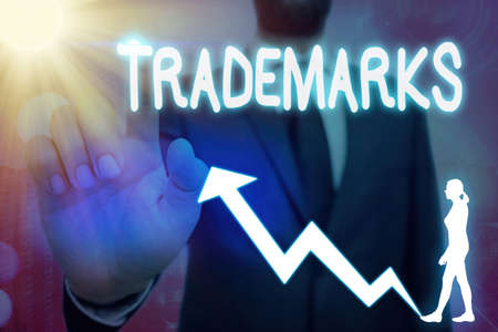 Conceptual hand writing showing Trademarks. Concept meaning legally reserved to the exclusive use of the owner as maker Arrow symbol going upward showing significant achievementの写真素材