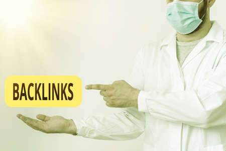 Word writing text Backlinks. Business photo showcasing links from one website to a page on another website or page Displaying Empty Sticker Paper Accessories Smartphone With Medical Gloves Onの写真素材