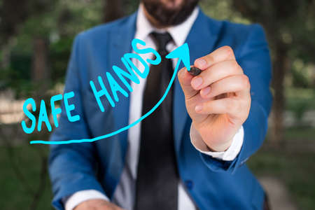Conceptual hand writing showing Safe Hands. Concept meaning Ensuring the sterility and cleanliness of the hands for decontamination Digital arrowhead curve denoting growth development conceptの写真素材