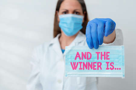 Conceptual hand writing showing And The Winner Is. Concept meaning announcing an individual or thing that wins something Laboratory blood test sample for medical diagnostic analysisの写真素材