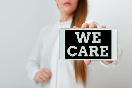 Conceptual hand writing showing We Care. Concept meaning Cherishing someones life Giving care and providing their needs Model displaying black screen modern smartphone mock-upの写真素材