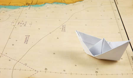 Paper boat on a navigational chart.