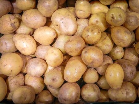 background vegetables, fresh potatoes on marketの写真素材