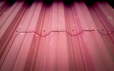 red background made of corrugated metal sheets, industrial wall, surface textureの写真素材