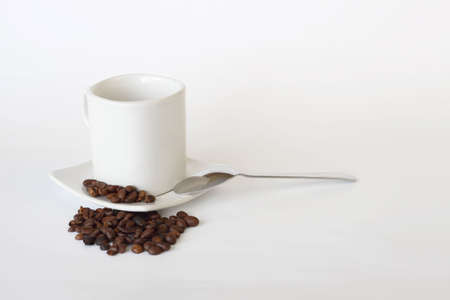 coffee mug, spoon and spilled coffee on white backgroundの写真素材