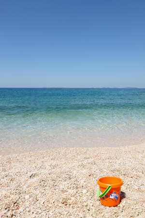 beautiful beach with child's bucket in Croatiaの写真素材