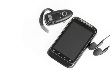 smartphone with headset handsfree and headphones isolated on white background
