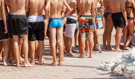 summer crowd of young waiting peoples for water atraction