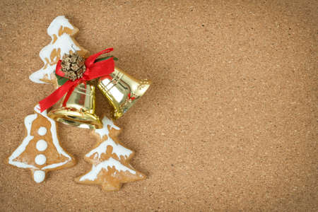 corc board with homemade ginger bread and christmas bells