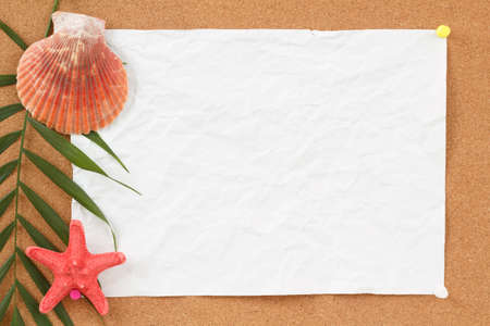 cocrboard with palm leave, crumpled paper and seashell for vacation messageの写真素材