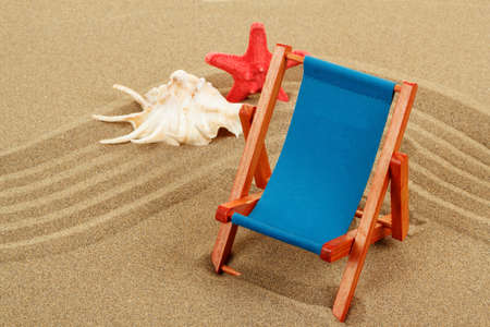 Still Life with seashell, starfish and sun lounger in beach sandの写真素材