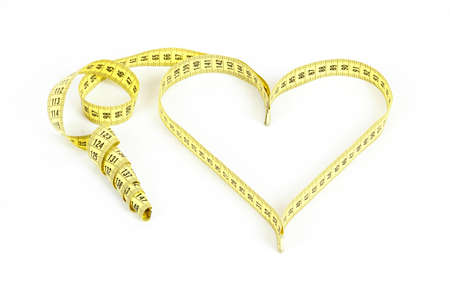 A measuring tape shaping a heart isolated on white backgroundの写真素材