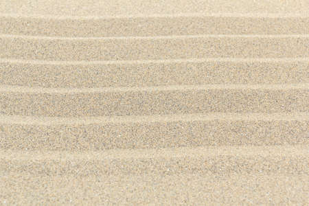 Sandy beach background with lines. Detailed sand texture. Top view の写真素材