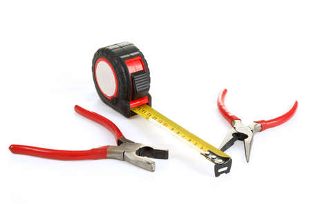 two different red pliers and measuring tape isolated on white