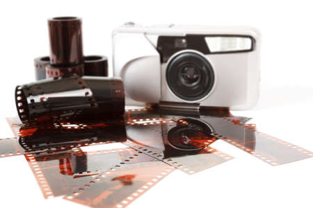 analog photo camera and color negative films on whiteの写真素材