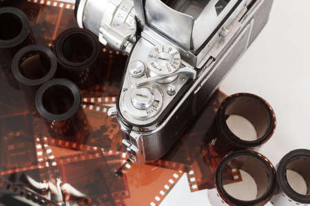 analog vintage SLR camera and color negative films on whiteの写真素材