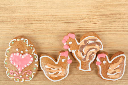 Easter gingerbreads rooster and hen on wooden backgroundの写真素材