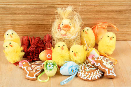 easter decoration, gingerbread, chicken and painted eggs wooden backgroundの写真素材