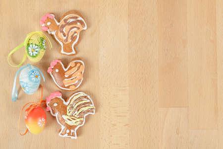 Easter ginger breads and painted egg on wooden backgroundの写真素材