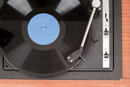 Spinning vinyl record. Motion blur image.  Vintage toned. Shallow depth of field.