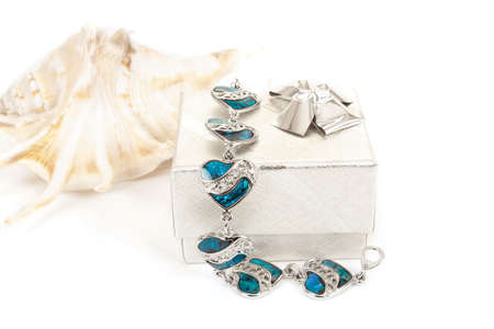 female bracelet with hearts and sea shell isolated on white の写真素材