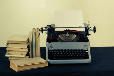 Old typewriter with paper and books, retro colors on the deskの写真素材