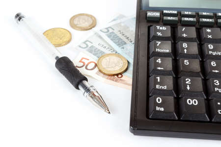 businessman workplace with money, coins, pen and calculatorの写真素材