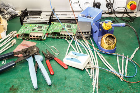 electronics equipment assembly workplace with solder and necessary tools