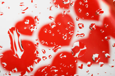 macro of water drop with heart on white backgroundの写真素材