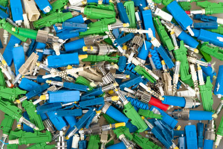 closeup of various types of fiber optic connectors for backgroundの写真素材