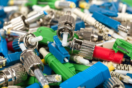 closeup of various types of fiber optic connectorsの写真素材