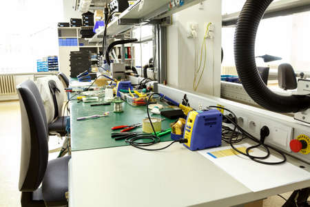 electronics equipment assembly workplace with pliers and necessary tools