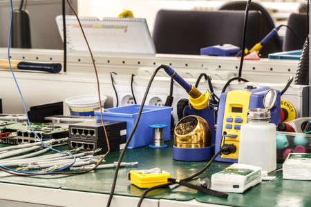 electronics equipment assembly workplace with pliers and necessary toolsのeditorial素材