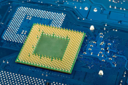 macro of computer processor on blue motherboard circuit