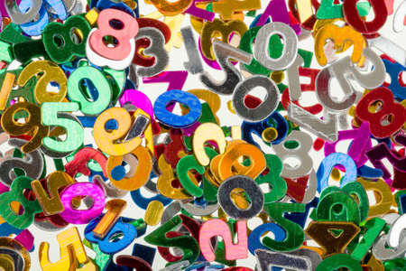 close up of small color numbers confetti background or backdropの写真素材