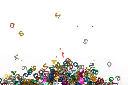 small color numbers confetti isolated on white backgroundの写真素材