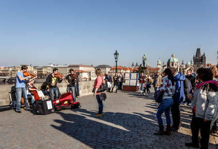 PRAGUE, CZECH REPUBLIC - MARCH 13: Charles Bridge on march 13, 2014 in Prague Czech Republic. Charles Bridge is a popular tourist attraction in Prague. On the bridge you can find many street artists.のeditorial素材